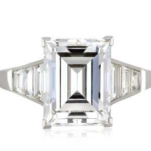 Art Deco step-cut diamond flanked solitaire ring, circa 1930.